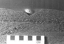 Experimental burial of a pebble in a flume